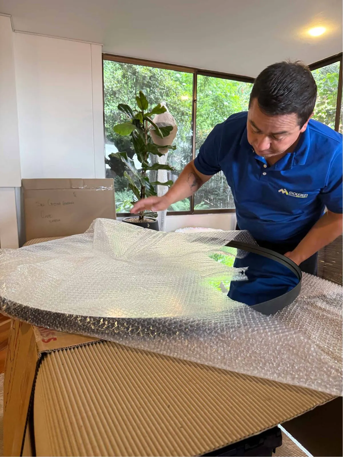 Mouber crew wrapping a glass table with bubble wrap